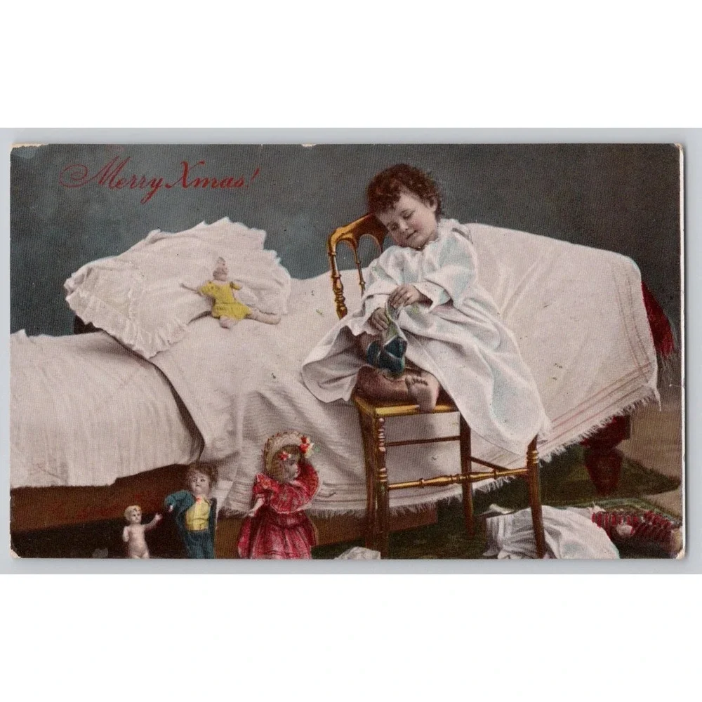 1913 Hand-Tinted Merry Christmas‎  Postcard– Smiling Child with Socks & Dolls